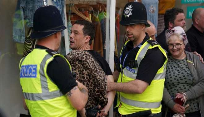 A man is detained by police officers during a protest in Nottingham, England Market Square on Saturday, Aug. 3, 2024, following Monday's stabbing attacks in Southport, in which three young children were killed. (Jacob King/PA via AP) (Jacob King/PA via AP)